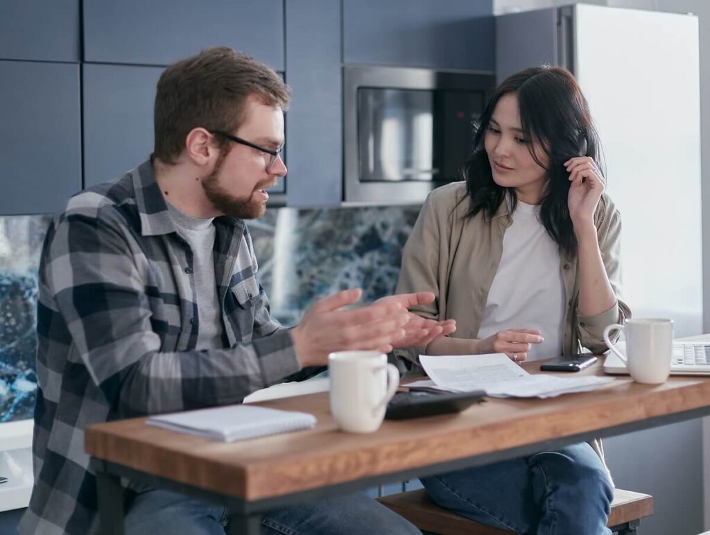 OwnershIP by Innovation Factory. Two entrepreneurs looking over intellectual property and legal documents on their desk as they have a discussion.